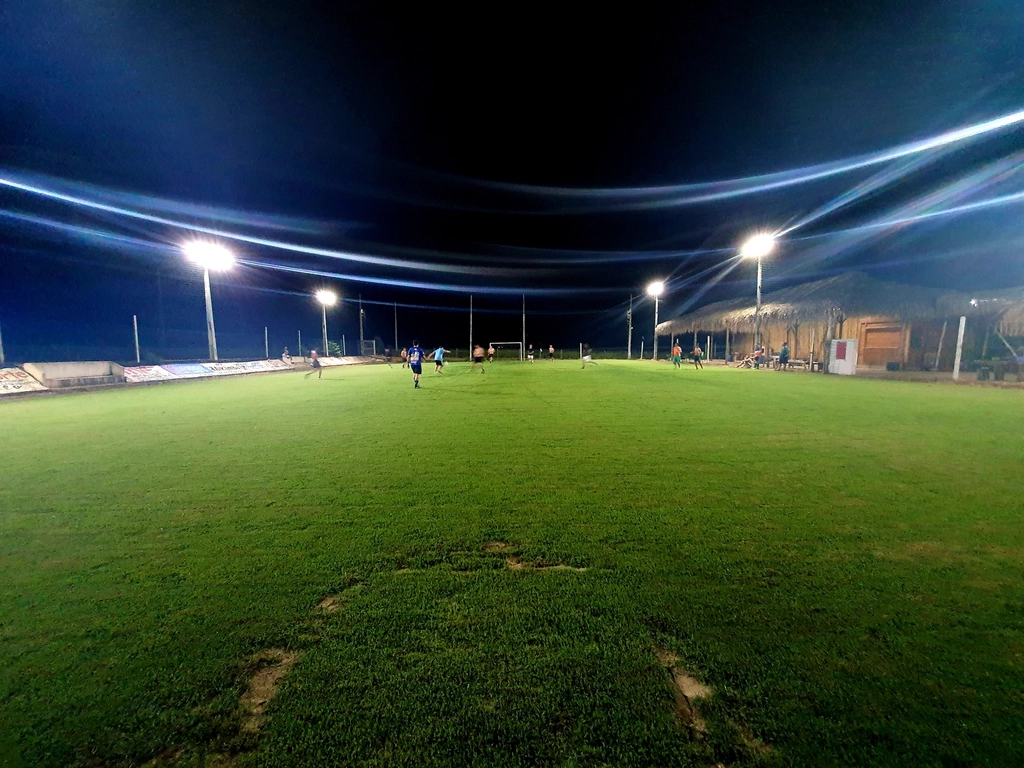 Stadium lights illuminating a sports field at night